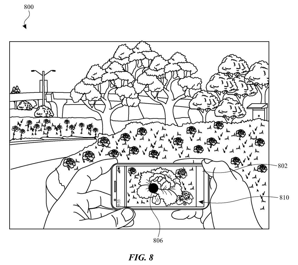 A smartphone camera view displaying a visual search indicator overlaid on a detected flower in a garden scene. Drawing from patent filing US 2026/0237205 A1.