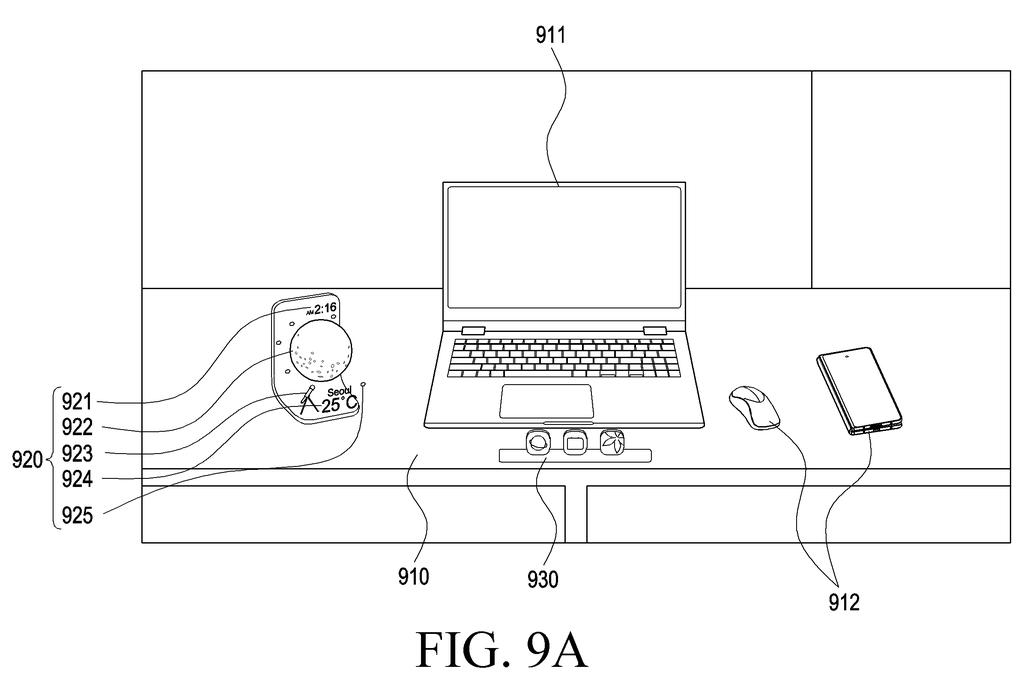 A virtual weather widget expands to fill a larger portion of the user's view, extending beyond the physical desk. Drawing from patent filing US 2026/0268616 A1.
