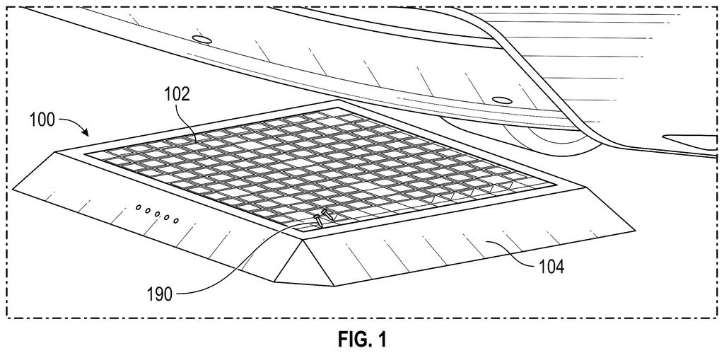A wireless charging pad is positioned beneath a vehicle, ready to transfer power without cables. Drawing from patent filing US 2026/0299157 A1.