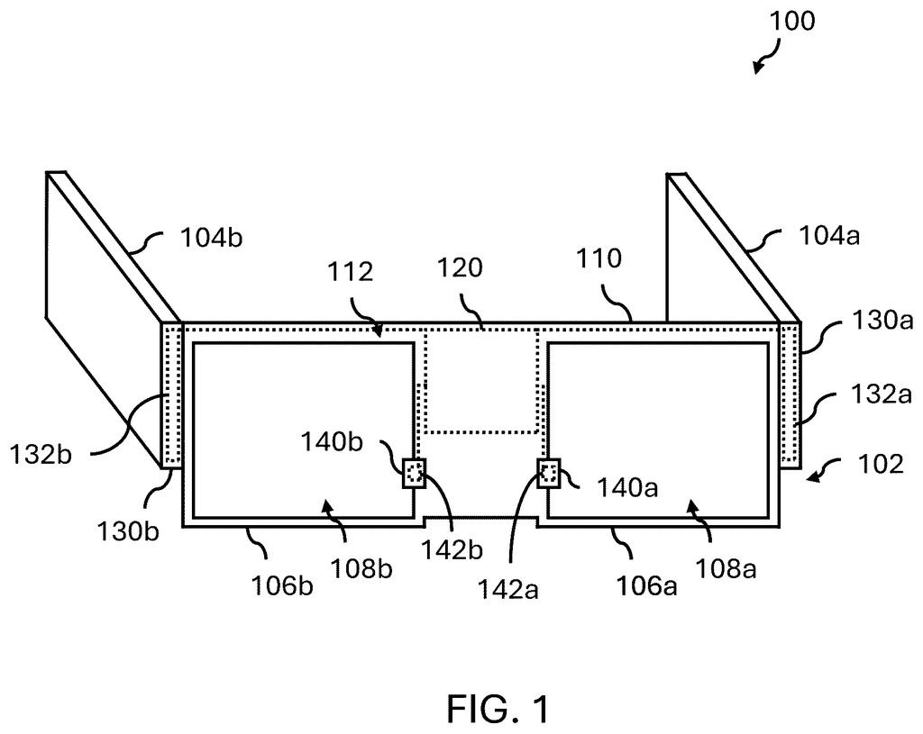 Smart glasses built with protective pockets that keep delicate computer parts safe while hot liquid plastic is molded around them. Drawing from patent filing US 2026/0329095 A1.
