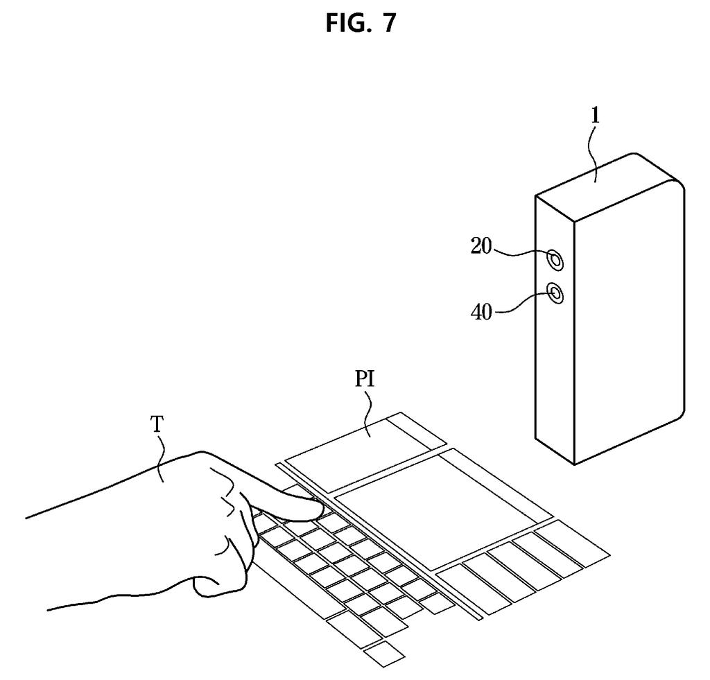 A portable projector casts an interactive keyboard onto a desk, using a single camera to track finger touches. Drawing from patent filing US 2026/0343110 A1.